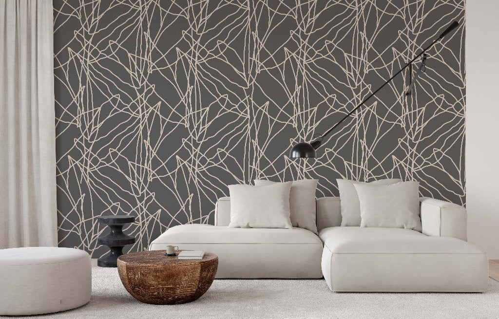 A modern living room featuring a white couch with pillows, two round poufs, and a wooden coffee table. The back wall is adorned with Decor2Go Wallpaper Mural.