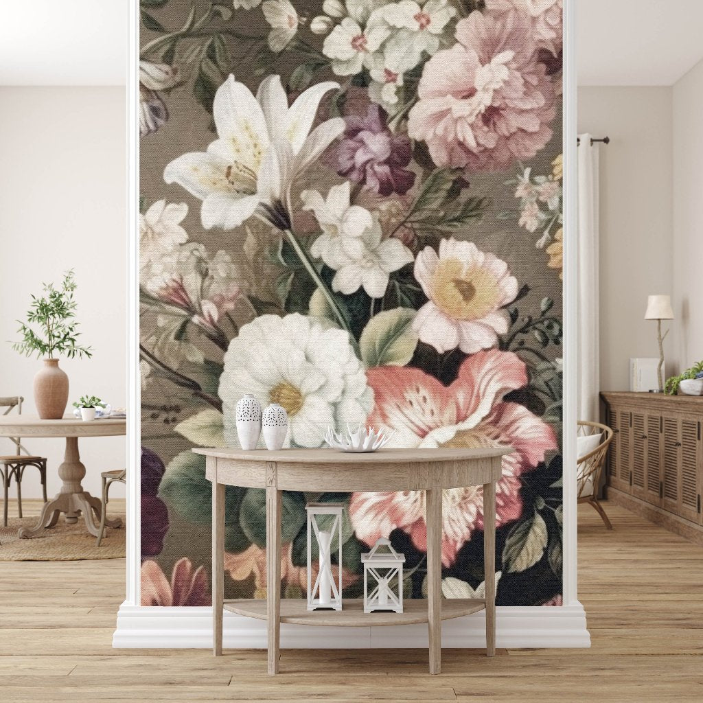 A room is adorned with the Decor2Go Wallpaper Mural's Blooming Meadow, featuring a large design of white, pink, and purple flowers on one wall. In front of the mural sits a wooden table decorated with lanterns. The room features wooden flooring, a small plant placed on a round table, and a cabinet topped with a lamp.
