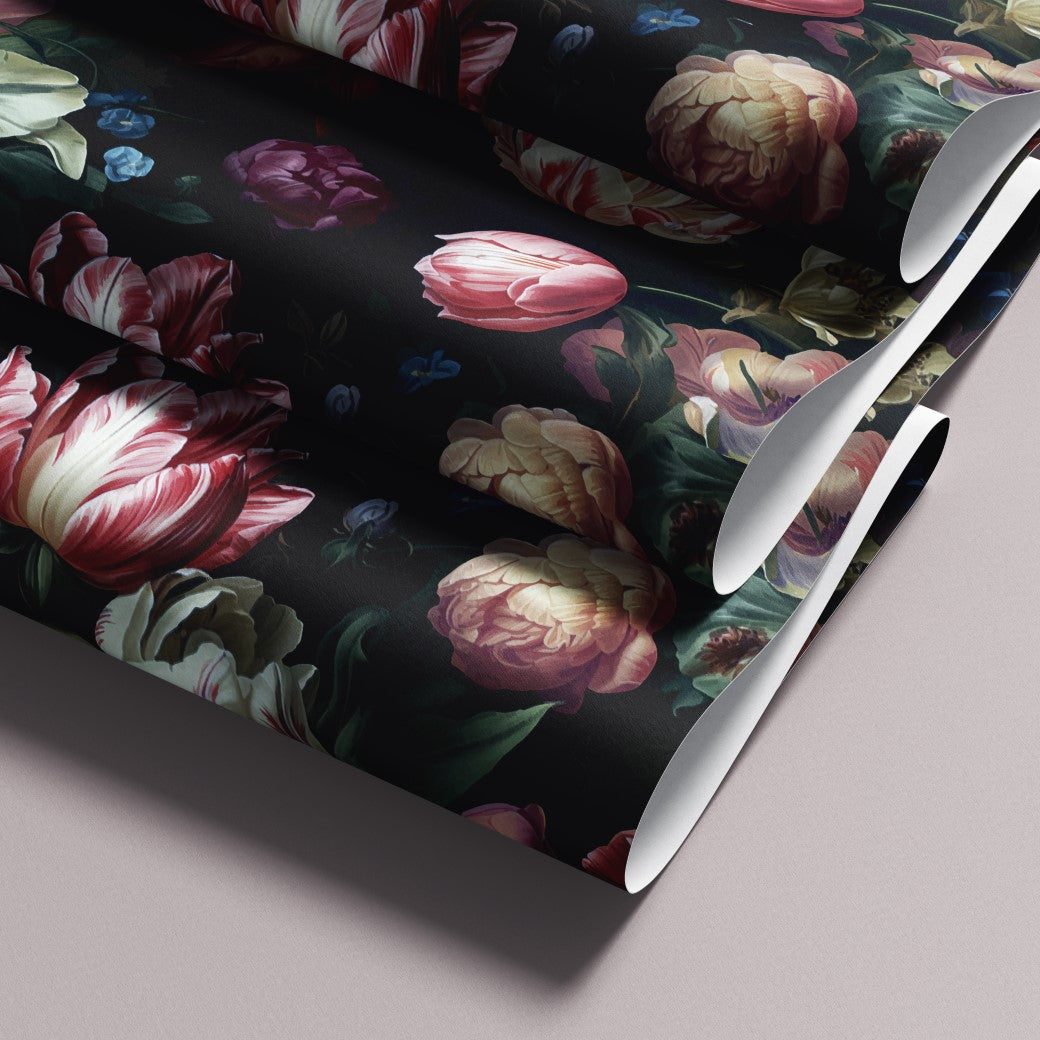 The Dark Elegance Floral Wallpaper Mural by Decor2Go features a luxurious design with pink, red, yellow, and blue flowers on a dark background. Its intricate and vibrant motifs are showcased elegantly when rolled.
