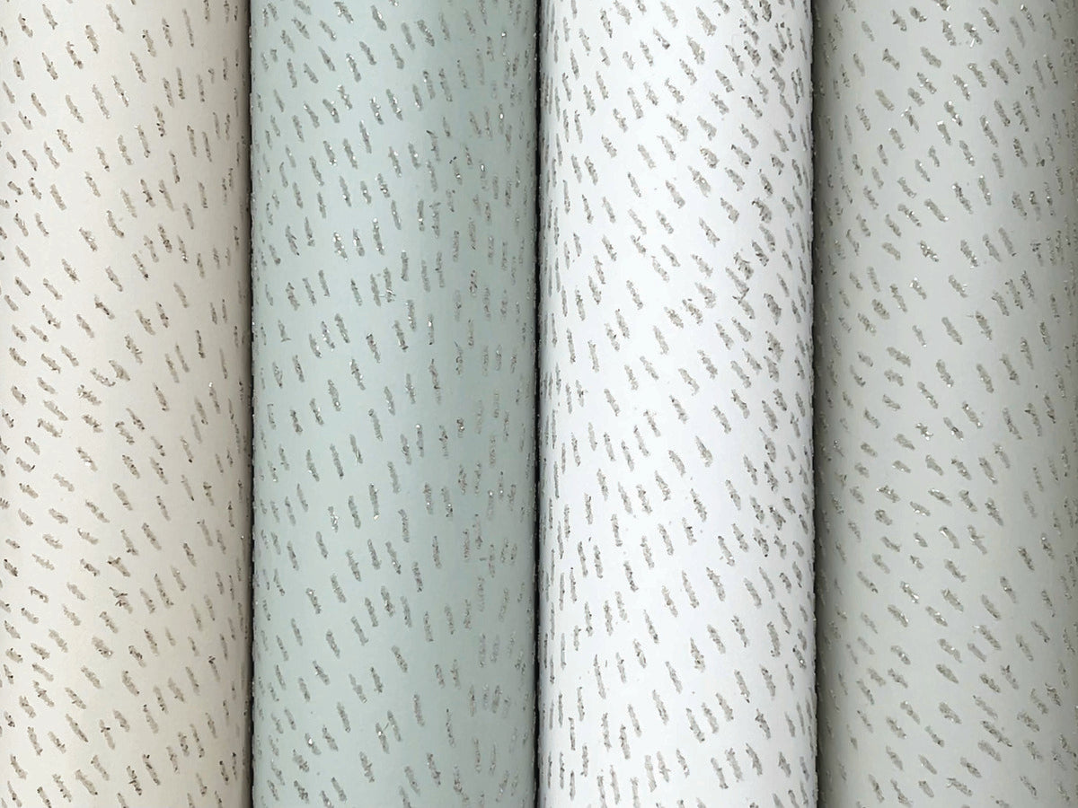 York Wallcoverings’ Dew Drop Sea Mist Wallpaper (60 SqFt) comes in four neutral hues—beige, light green, off-white, and pale grey—with a subtle vertical metallic dash pattern for a sparkling yet understated look.