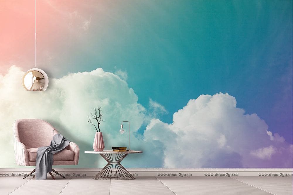 A creative indoor room setup featuring a soft pink armchair with a gray throw, a round table with books and a vase, under a ceiling that artistically transitions from Decor2Go Wallpaper Mural.