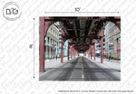 A wide, empty urban street lies beneath an elevated metal train track supported by beams. The urban railway flanks the street with buildings on both sides, creating a tunnel-like effect. The dimensions 10' (width) and 8' (height) are indicated above and to the left of the image. This is the Urban Railway Wallpaper Mural by Decor2Go Wallpaper Mural.