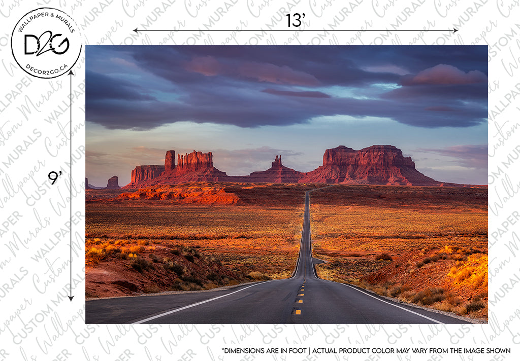 A scenic view of a straight road leading towards distant red rock formations under a vibrant sunset sky, bathed in warm light. Branded as "Decor2Go Wallpaper Mural" and watermarked