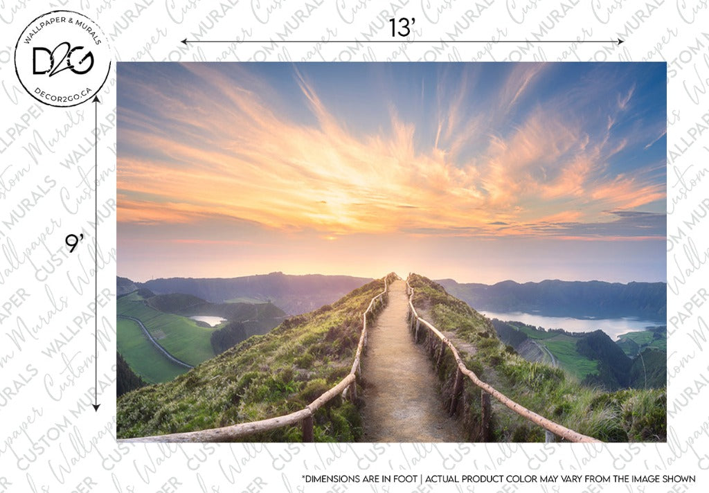 A scenic custom Mountaintop Trail Wallpaper Mural from Decor2Go Wallpaper Mural showing a wooden pathway leading through lush green hills towards a vibrant sunset with clouds scattered across the sky. Text and logos indicate design specifications.