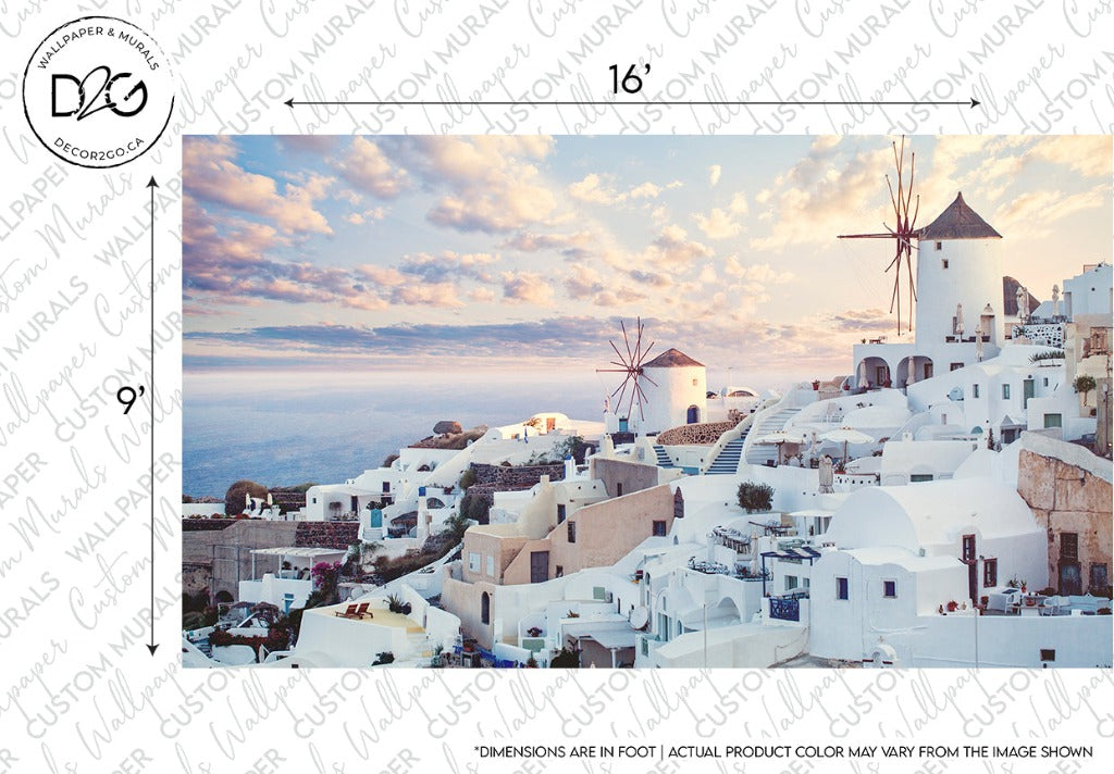 A picturesque view of a coastal town featuring white-washed buildings with blue domes, several windmills, and a beautiful sunset sky. The town appears to be built on a hill overlooking the sea. The Decor2Go Wallpaper Mural Santorini Skyline Wallpaper Mural captures the Mediterranean aesthetic with soft clouds and pastel colors.