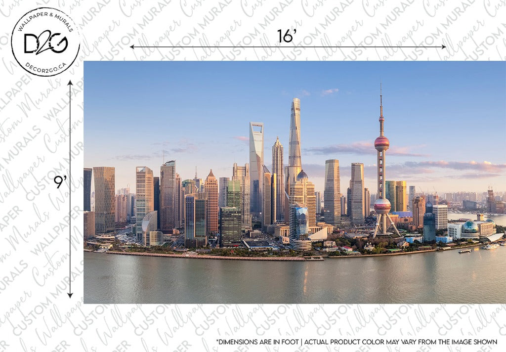Panoramic view of Shanghai's skyline featuring modern skyscrapers, including the Oriental Pearl Tower, under a clear sky at sunset, with the waterfront visible. Check out the Shanghai Skyline Wallpaper Mural by Decor2Go Wallpaper Mural.
