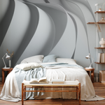 Bedroom with 3D waves mural in the background  