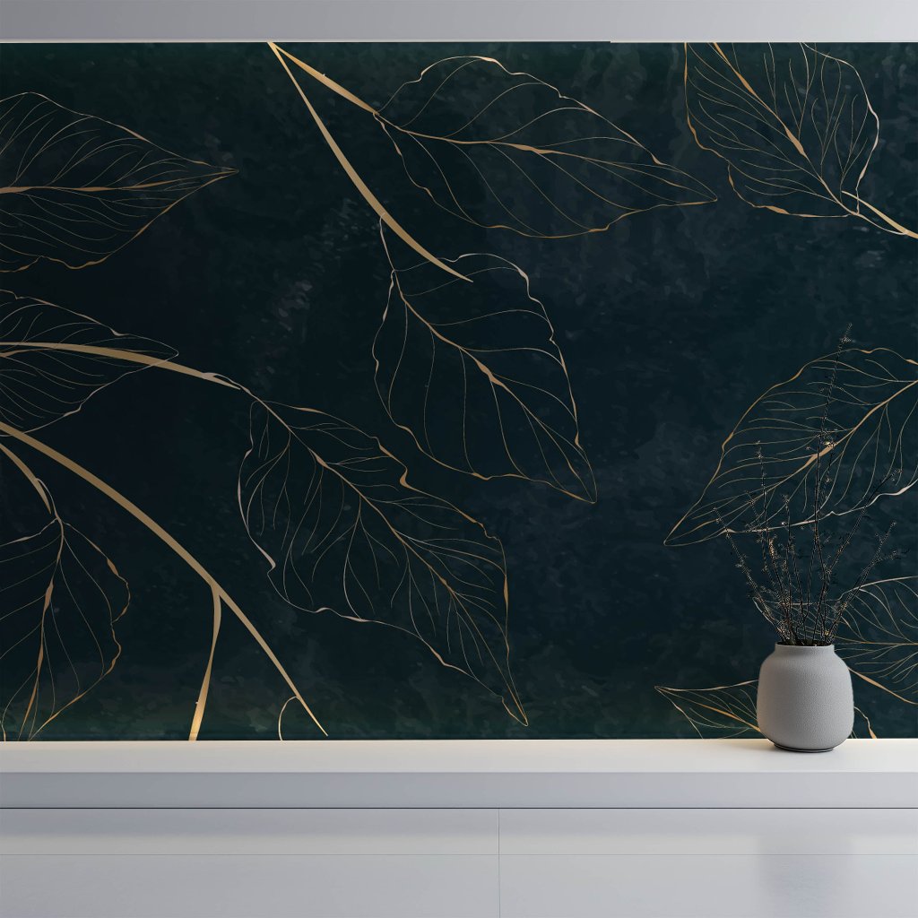 A dark green wall enhanced by Decor2Go's Golden Leaves Wallpaper Mural showcases an intricate gold leaf design. A sleek gray vase, adorned with delicate branches, rests on a white surface, capturing the essence of Nature's Elegance through its graceful leaf outlines.