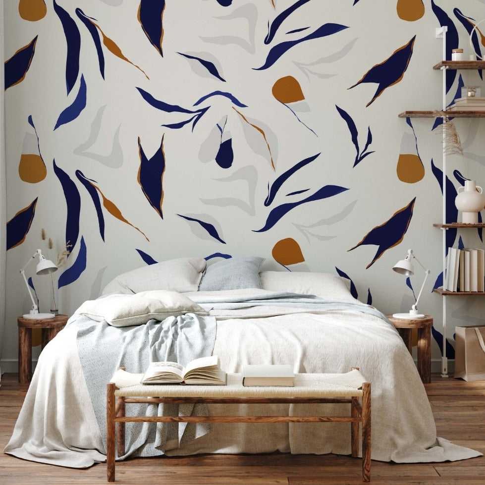 A modern bedroom with a Decor2Go Wallpaper Mural Neutral Abstract mural, featuring a large bed, wooden bedside tables, shelves, and a minimalist wooden bench with an open book.