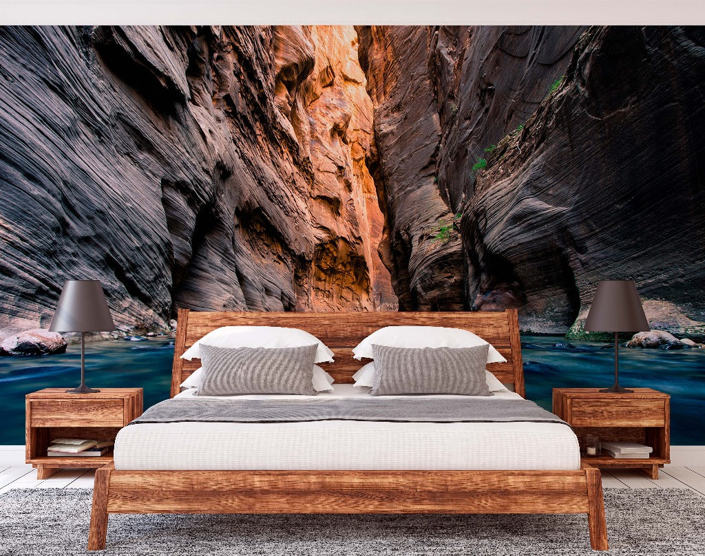 Bedroom - A modern bedroom featuring a minimalist wooden bed with white bedding, flanked by two side tables with lamps, set against a large wall mural of Decor2Go Wallpaper Mural with towering rock walls.