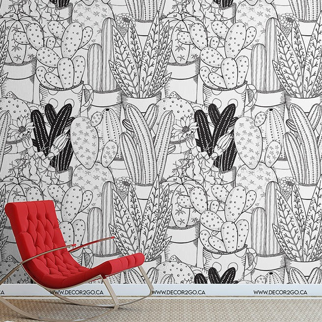 A bright red modern chair stands in front of a wall adorned with a Decor2Go Wallpaper Mural featuring various Cactus Clan illustrations.