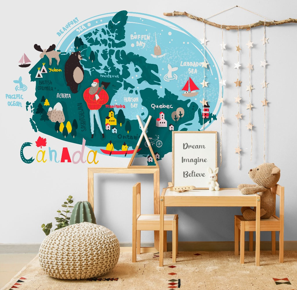 A colorful children’s room with a large Decor2Go Wallpaper Mural on the wall, a small wooden desk and chair, plush toys, and decorative elements like a hanging mobile and potted plant.