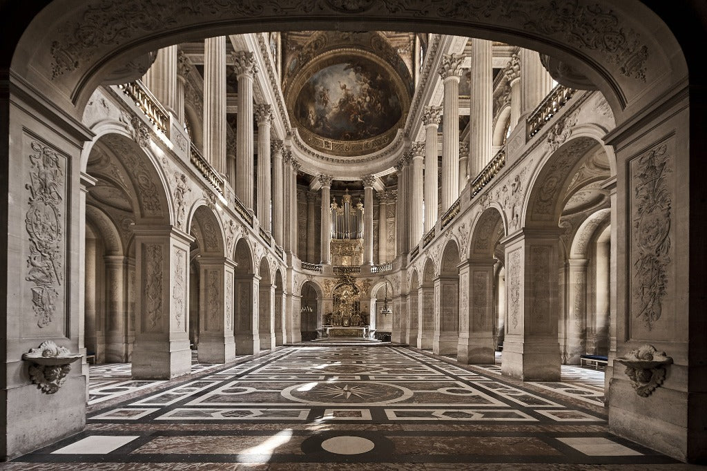 View of the grand interior of the palace of Versailles's hall of mirrors seen from an arched doorway, highlighting the ornate architectural details and ceiling paintings, reminiscent of a Decor2Go Wallpaper Mural.