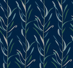 Seamless floral pattern featuring elegant, elongated leaves in shades of green and gray on a dark blue background. This removable Chloe Vine River Rock Wallpaper from York Wallcoverings is stylized and repetitive, creating a tranquil, naturalistic texture.