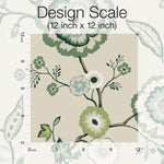A measurement scale is displayed on a floral pattern to represent a 12 inch by 12 inch design. The pattern features green and white flowers with detailed leaves and branches against a neutral background, exuding botanical elegance. This design scale is perfect for evaluating Dahlia Blooms Midnight/Multi Wallpaper Black, Pink (60 Sq.Ft.) by York Wallcoverings.