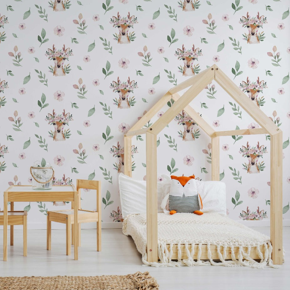 A cozy children's room featuring a wooden house-shaped frame bed with white linens and a fox pillow, a small wooden table and chairs, set against a Decor2Go Wallpaper Mural.