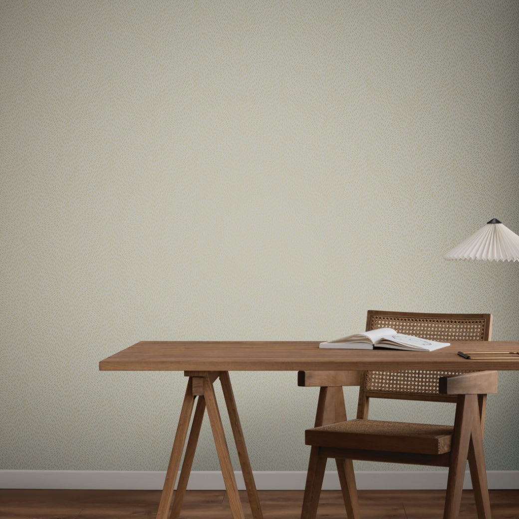 A minimal desk scene featuring a wooden table, open book, wooden chair with woven back, and modern white lamp, set against York Wallcoverings Dew Drop Grey Wallpaper (60 SqFt) for a subtle touch of color.