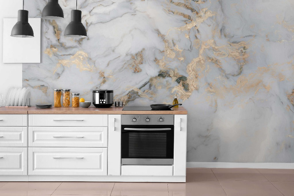 A modern kitchen with white cabinets and a marble backsplash featuring blue and gold veins. There's an electric stove, oven, black utensils, and a kettle on the counter. Three pendant lights hang Decor2Go Wallpaper Mural Dreamscape Wallpaper Mural.
