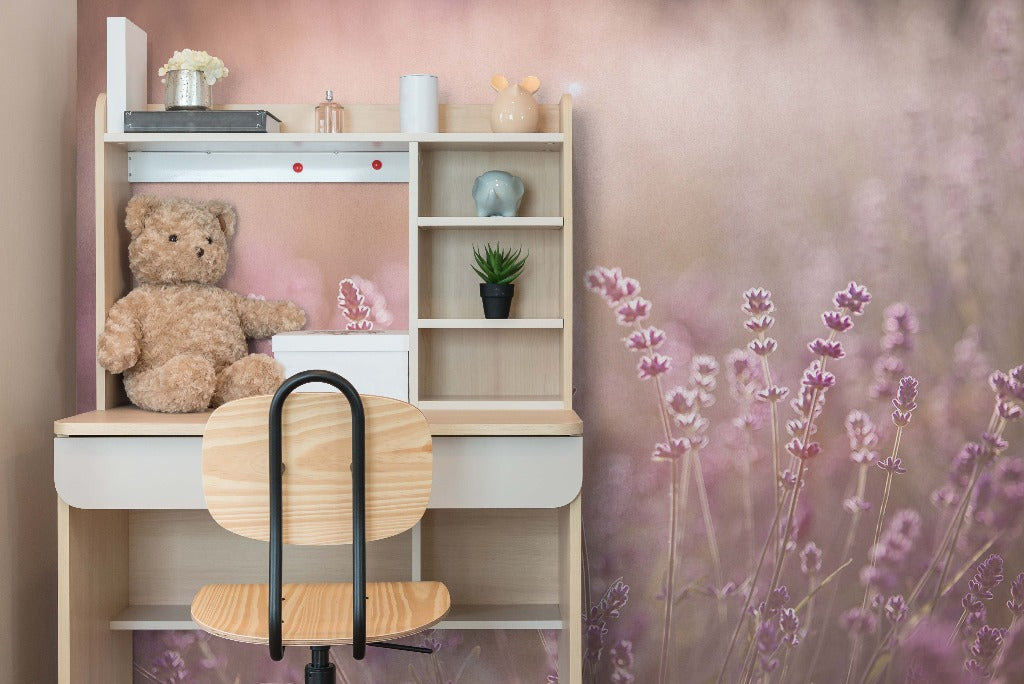 A cozy children's room corner featuring a wooden shelf with a teddy bear, books, and decorative items. A small chair with a curved backrest stands in the foreground, against Decor2Go Wallpaper Mural's Field of Dreams Wallpaper Mural.