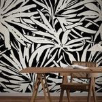 A desk and chair sit in front of a wall adorned with York Wallcoverings’ Floral Canopy Black Wallpaper Mural (Panels).