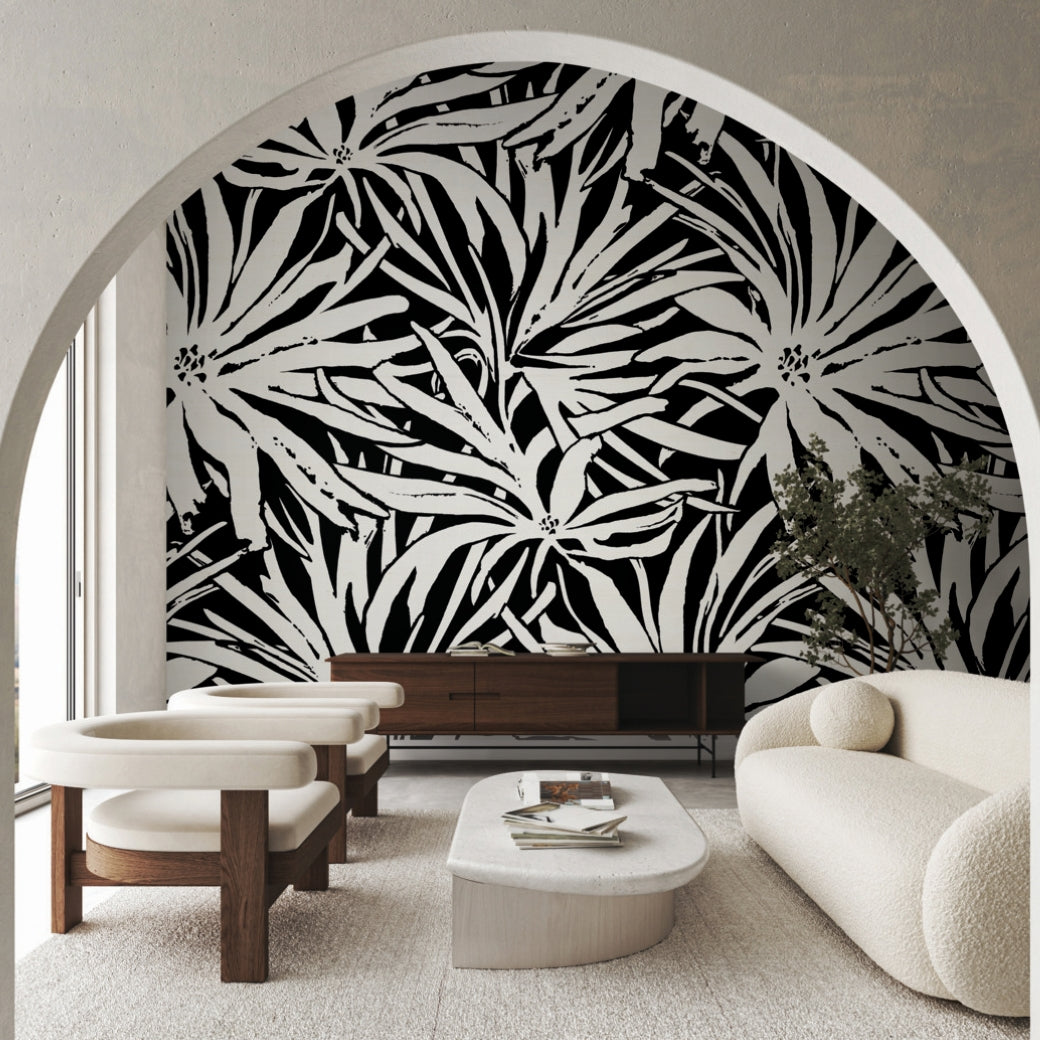 Modern living room with cream furniture, a white oval coffee table, and York Wallcoverings’ Floral Canopy Black Wallpaper Mural as a striking feature wall, viewed through a large archway.