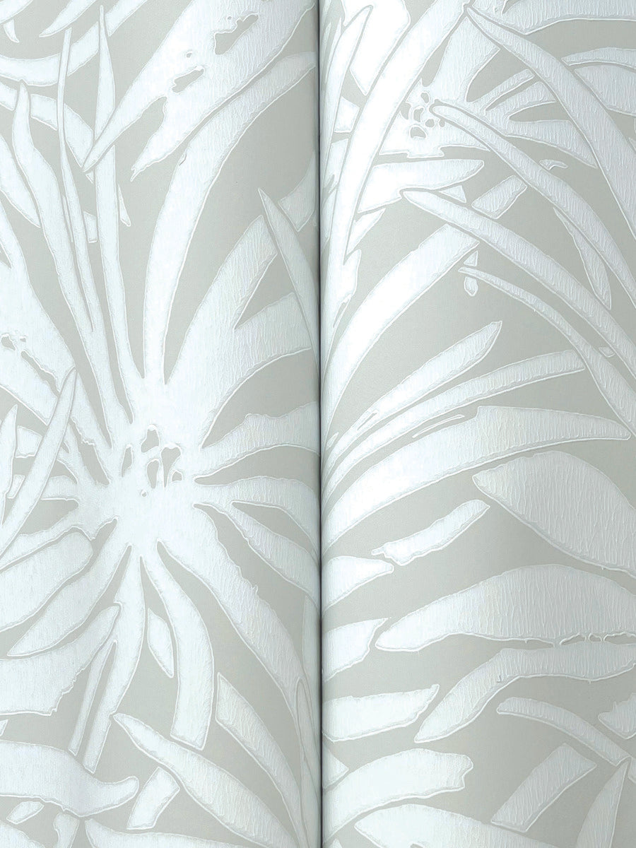Close-up of York Wallcoverings' Floral Canopy Grey Wallpaper (60 SqFt), showing glossy white abstract floral and leaf patterns on a matte light gray background, with a visible seam where two wallpaper panels meet.