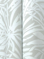 Close-up of York Wallcoverings' Floral Canopy Grey Wallpaper (60 SqFt), showing glossy white abstract floral and leaf patterns on a matte light gray background, with a visible seam where two wallpaper panels meet.