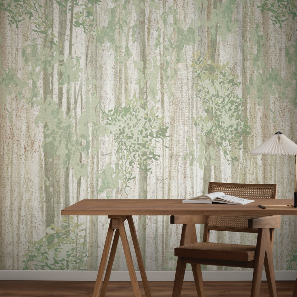 A wooden desk and chair face a wall adorned with the Aspen Grove Forest Wallpaper Mural (2 Panels) by York Wallcoverings. On the desk are an open notebook, pen, and pleated lamp, creating a calm, minimalist workspace.