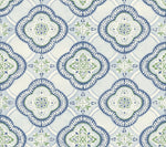 A decorative tile pattern features repetitive, ornate motifs in shades of blue and green. The central design is surrounded by leaf-like details encased in a dark blue outline, creating a symmetrical and intricate appearance reminiscent of York Wallcoverings Garden Trellis Onyx Wallpaper Black, Grey (60 Sq.Ft.). The background is a light cream color.