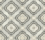 A seamless pattern featuring intricate, symmetrical, floral-like designs within interlocking diamond shapes. The pattern consists of shades of grey, black, white, and beige, creating a visually appealing and elegant look reminiscent of vintage tile work—a perfect choice for removable wallpaper like the Garden Trellis Cobalt Wallpaper Blue (60 Sq.Ft.) from York Wallcoverings with botanical elegance.