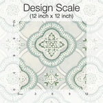 A detailed design scale of a 12-inch by 12-inch decorative tile pattern featuring intricate, symmetrical floral and vine motifs in shades of green and white. Measurement markers are indicated along the edges to show the scale, exuding botanical elegance reminiscent of York Wallcoverings' Garden Trellis Onyx Wallpaper Black, Grey (60 Sq.Ft.).