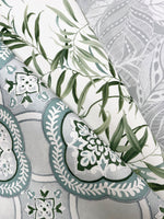A detailed image of three overlapping rolls of removable wallpaper. The top roll has a green and white leafy design evoking botanical elegance, the middle roll features a teal and white floral pattern, and the bottom roll has an intricate grey and white geometric design, showcasing York Wallcoverings' Garden Trellis Cobalt Wallpaper Blue (60 Sq.Ft.).