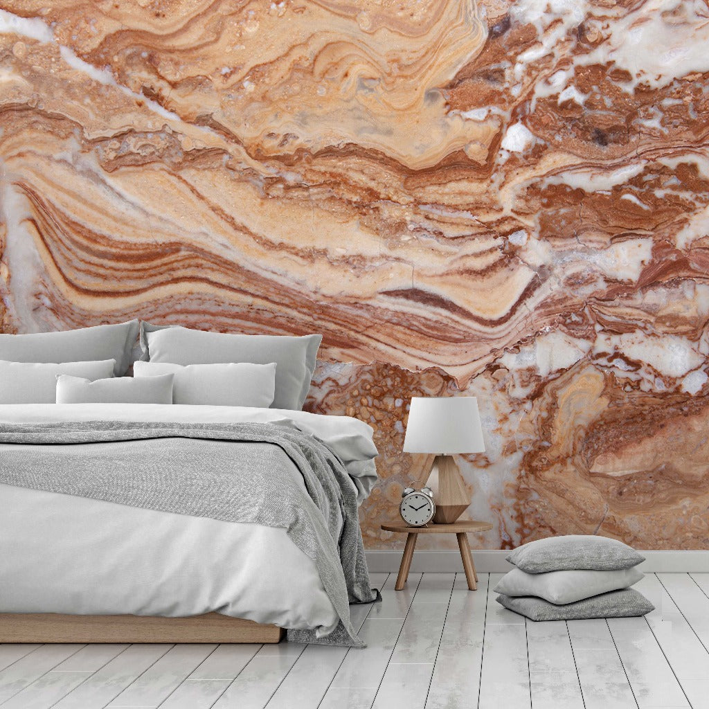 Bedroom - A modern bedroom featuring a bed with gray bedding and a Gemstone Diffused Marble Wallpaper Mural in earthy tones from Decor2Go Wallpaper Mural. A wooden bedside table with a lamp and clock is next to the bed, and a