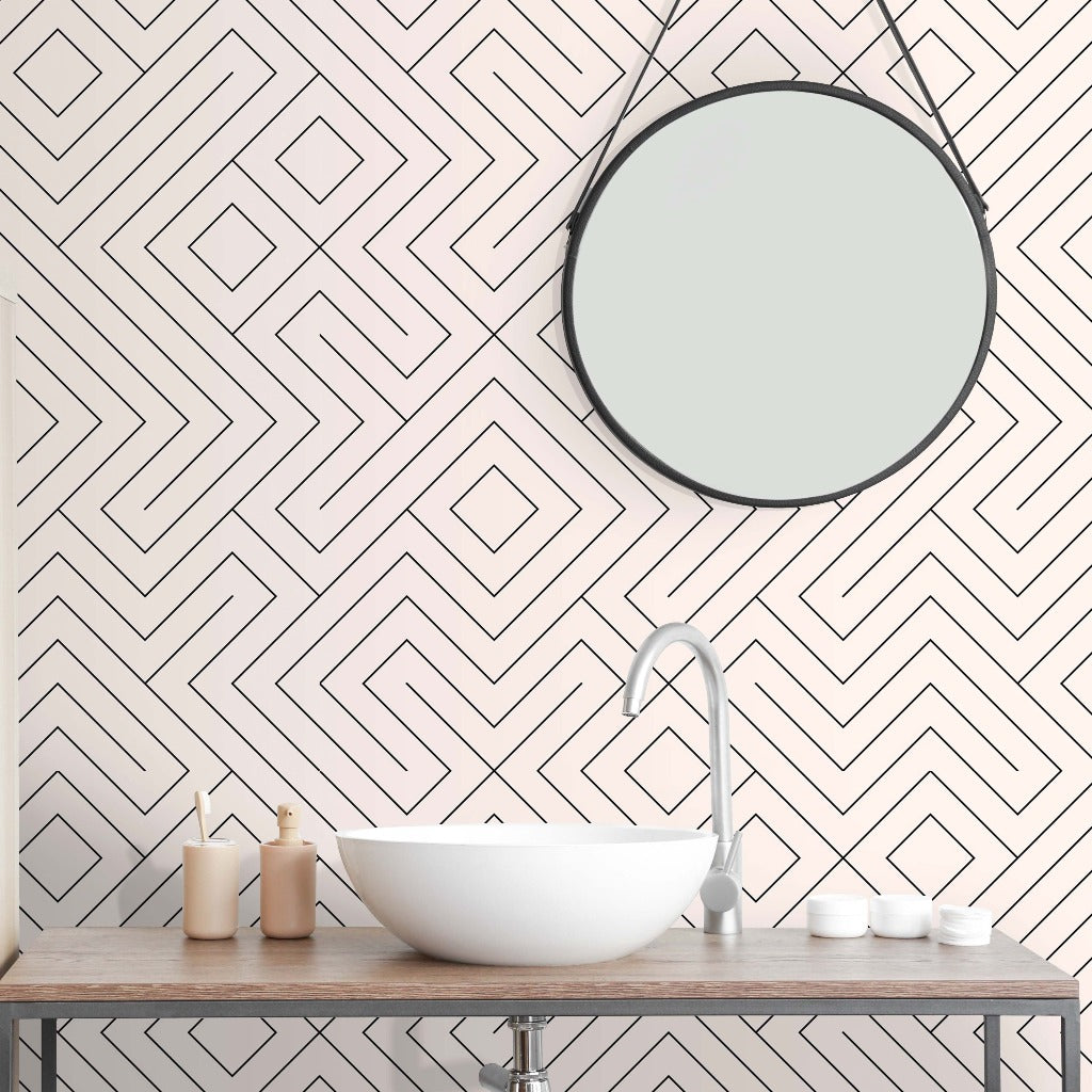 Bathroom with gold lighting and a soft wallpaper with a maze pattern