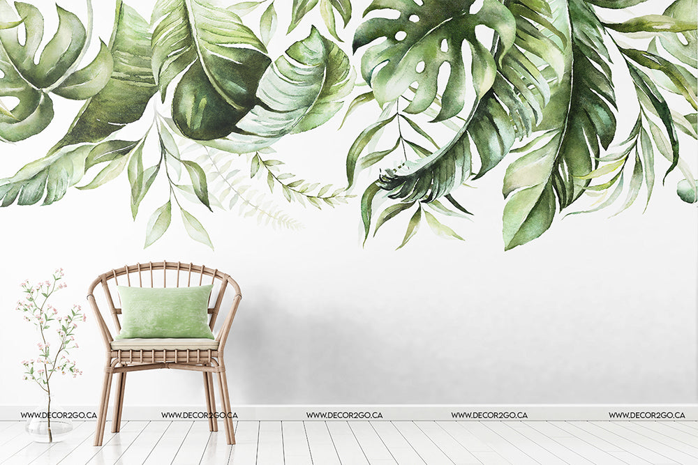 A minimalist interior scene featuring a wooden chair with a green cushion against a white wall adorned with Decor2Go Wallpaper Mural's "Green is in the air" wallpaper of lush green leaves.