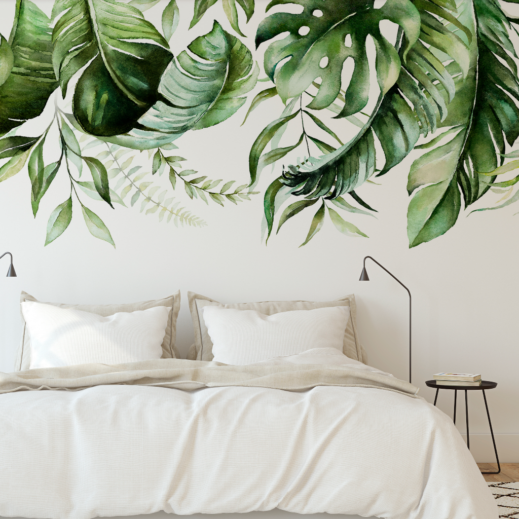 A minimalist bedroom with white bedding and pillows on a bed, flanked by black bedside lamps, against a wall adorned with the Decor2Go Wallpaper Mural "Green is in the air" Wallpaper Mural.