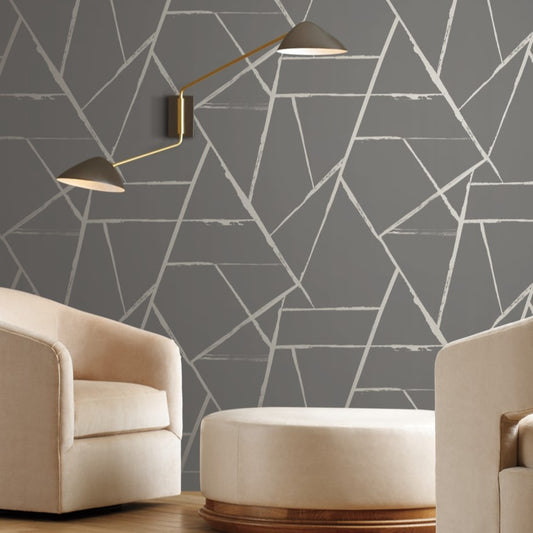 Living room furniture with a modern design, warm light and geometric lines wallpaper