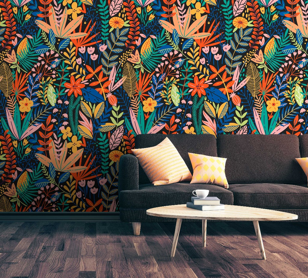 A modern living room featuring a dark gray sofa with colorful cushions, a white oval coffee table with a cup and saucer on it, against a vibrant Heart of the Jungle Wallpaper Mural from Decor2Go Wallpaper Mural, and wooden flooring.