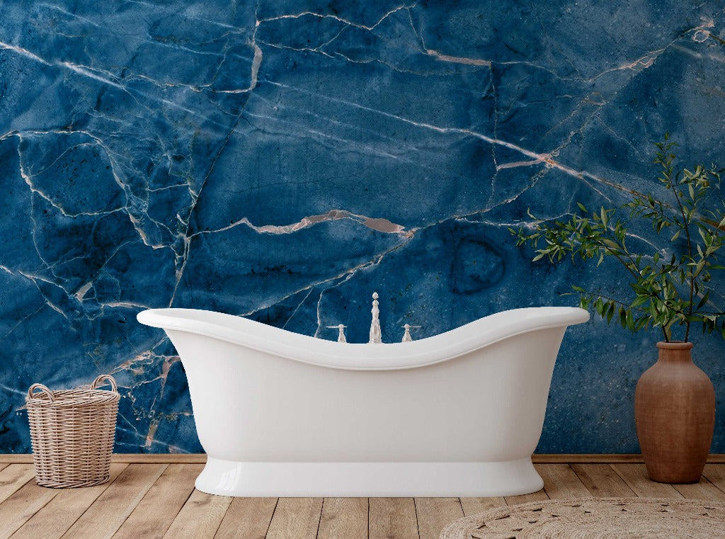A serene bathroom setup featuring a white clawfoot bathtub against a vibrant Decor2Go Wallpaper Mural, with a potted plant and a woven basket beside it.