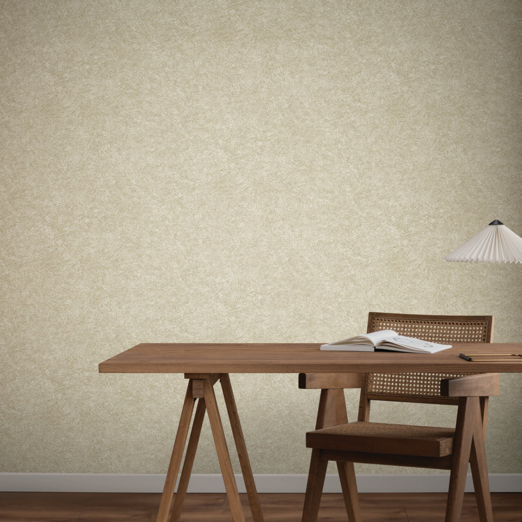 Home Office - A minimalist with a wooden desk, chair, open book, notebook, and white pleated lamp sits against a beige wall covered in York Wallcoverings' Impression Sand Wallpaper—ideal for contemporary interiors