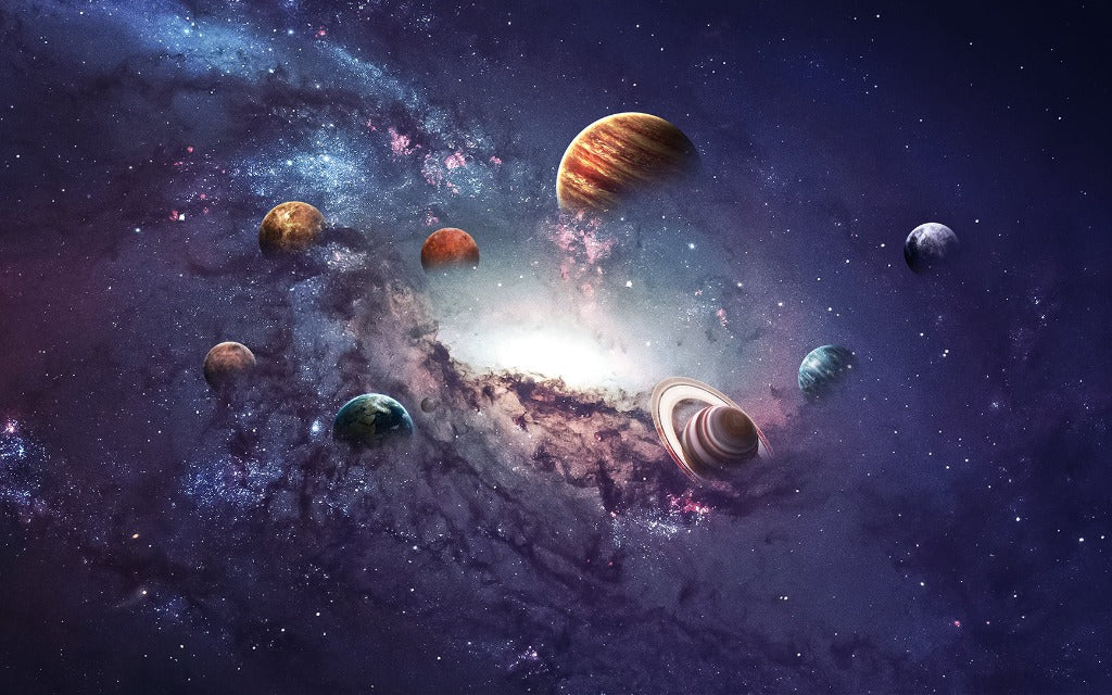 Digital illustration of a cosmic scene featuring a swirling galaxy with vibrant nebulas and bright stars. Multiple planets of various sizes and colors, including a prominent ringed planet, orbit within the galaxy, creating the perfect Decor2Go Wallpaper Mural Lost in Space Wallpaper Mural for any space enthusiast.