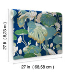 Introducing York Wallcoverings Lotus Pond Heather/Cotton Wallpaper Grey, Blue (60 Sq.Ft.): a roll featuring a botanical pattern with large leaves and flowers in shades of green, white, and beige on a dark blue background. Measuring 27 feet long and 27 inches wide, this wallpaper offers easy installation for a tranquil design touch to any room.