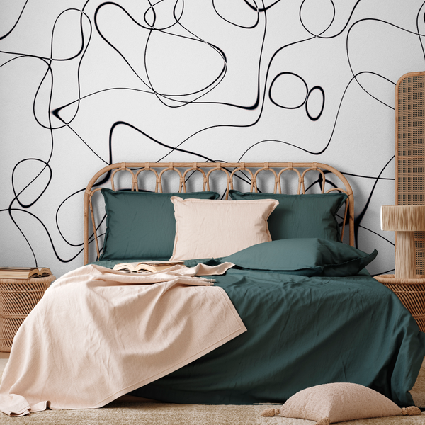 Bedroom - A stylish modern bedroom featuring a Decor2Go Wallpaper Mural on a white wall, with a rattan headboard, dark green bedding, a beige throw, and matching pillows.