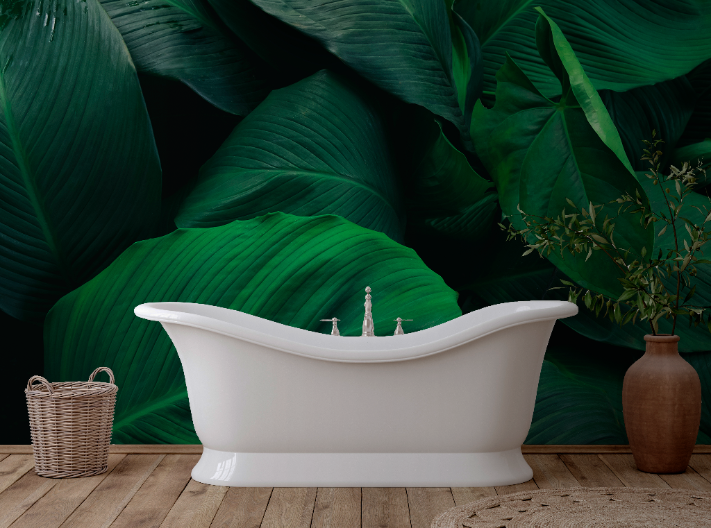 A white freestanding bathtub in a tropical-themed bathroom with Decor2Go Wallpaper Mural, a wooden floor, and a brown vase next to a wicker basket.