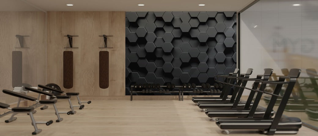 Experience a modern gym with premium quality wooden flooring and a sleek design. On the left side, you’ll find several fitness machines, while the middle section is dedicated to a collection of dumbbells. The right side hosts treadmills, and the back wall is adorned with Decor2Go Winnipeg's striking Modern 3D Hexagonal Elegance Wallpaper Mural.