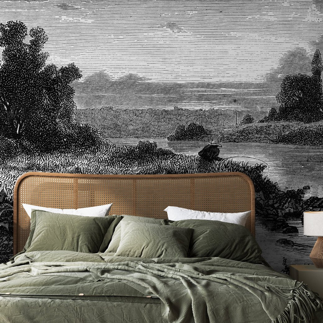 A bed with green linens and pillows is placed against a wall adorned with the Mystic Lake Wallpaper Mural from Decor2Go Winnipeg. The mural, detailed with trees, water, and sky, creates a serene ambiance that evokes lush greenery in the bedroom.