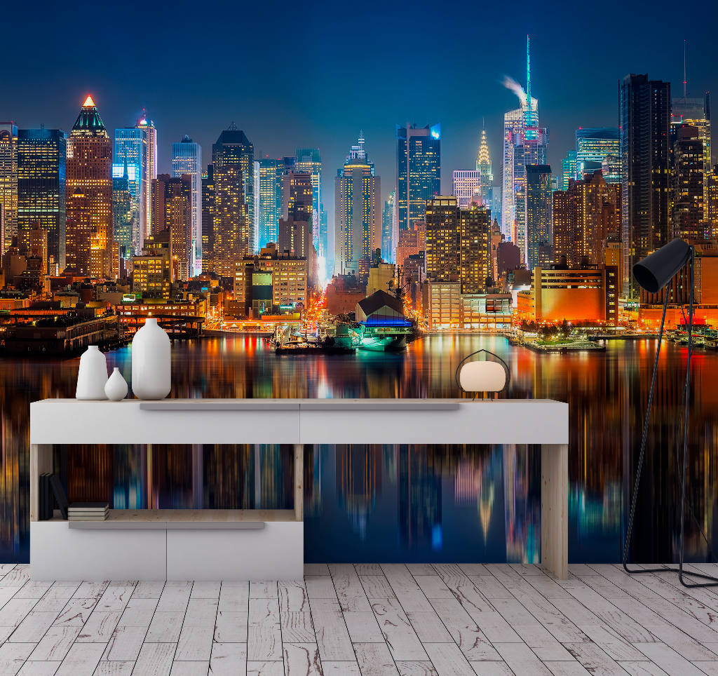 A modern living room with a sleek console table featuring decorative items, set against a vibrant Decor2Go Wallpaper Mural of the New York City skyline at night.