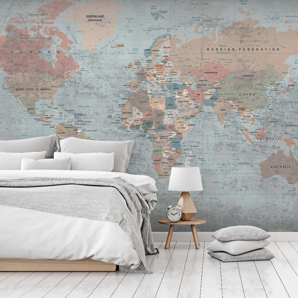 A serene bedroom featuring a Decor2Go Wallpaper Mural, a neatly made bed with gray bedding, a white pillow, a wooden bedside table with a clock, and a cushion on the floor.