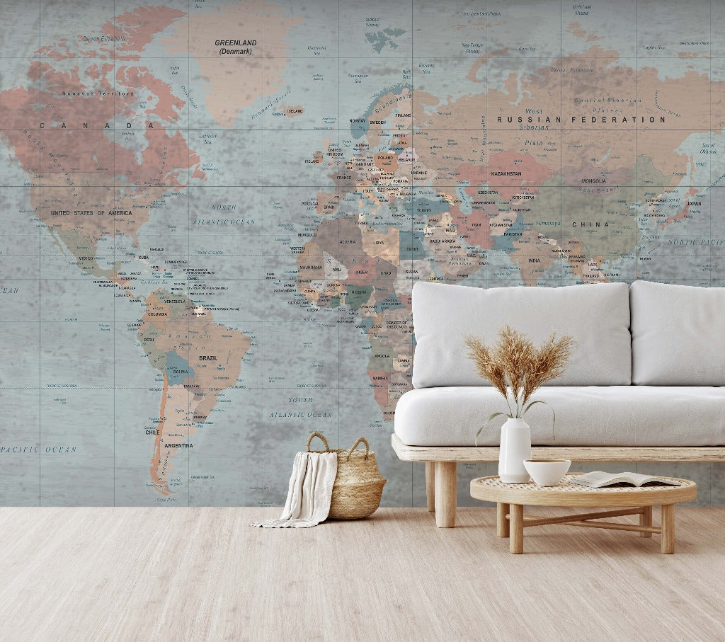 A minimalist living room featuring a white sofa and a wooden coffee table, with a Decor2Go Wallpaper Mural on the wall behind it. A vase of dried flowers and a woven basket add to the.