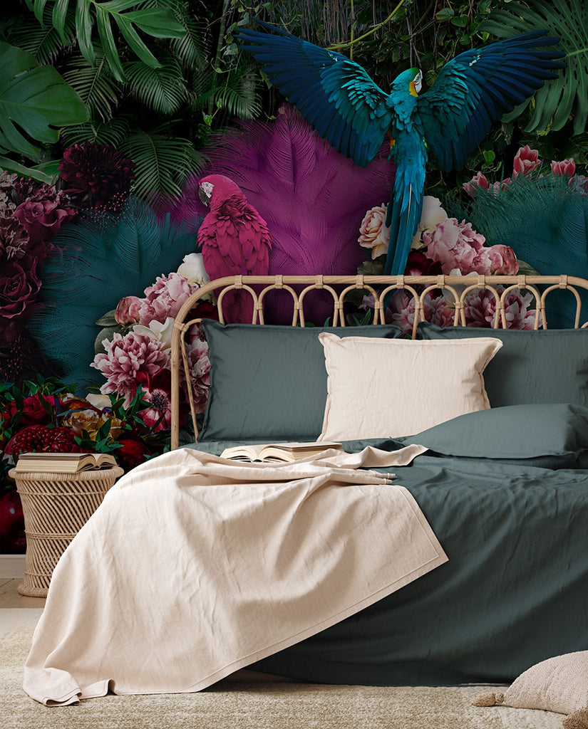 A vibrant bedroom with a tropical paradise theme, featuring a bed with dark green bedding and a beige throw. The Parrot Paradise Wallpaper Mural from Decor2Go Wallpaper Mural is adorned with colorful jungle foliage and flowers, with majestic parrots perched throughout.